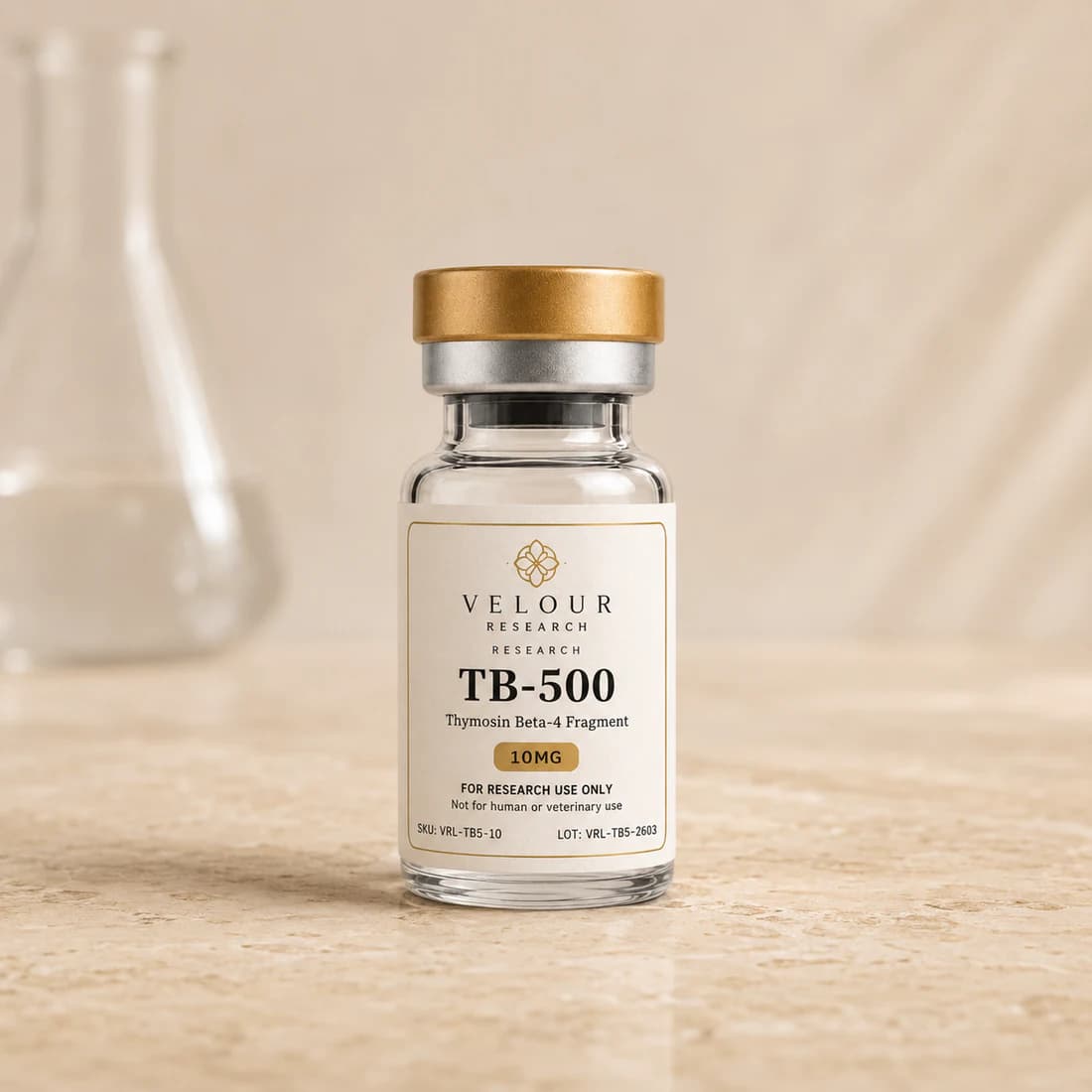 Velour Research TB-500 vial with a satin gold cap on a warm limestone counter